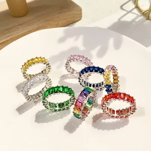 Detail of eternity rings with colorful princess cut zircon stones in silver claw setting