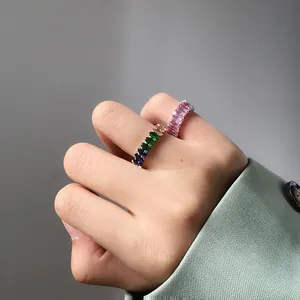 Detail of colorful and purple zircon stackable s925 silver rings on fingers