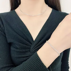 Elegant 2mm zircon tennis necklace and bracelet set in silver finish on a model