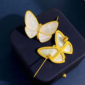 Elegant gold butterfly brooch with white mother of pearl inlay and sparkling crystals