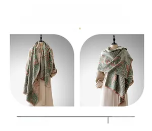 Detail of paisley pattern and tassels on soft warm cashmere-feel pashmina shawl for women