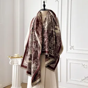 Detail of vintage floral toile pattern on warm burgundy and cream pashmina scarf