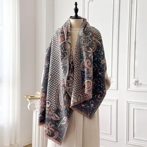 Detail of paisley patterns and soft fringe on a thick vintage style shawl wrap scarf
