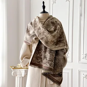 Detailed view of dark brown floral cashmere-feel scarf with elegant fringe tassels