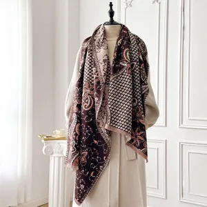Detail of paisley and floral shawl with soft tassels in a stylish home setting