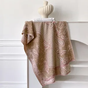 Detail of paisley pattern and pink fringe on vintage pashmina scarf with soft texture
