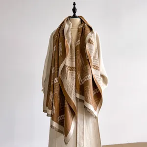 Detail of geometric pattern and fringe on heavy dark brown and beige winter scarf