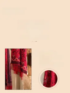 Close-up of ethnic red pashmina scarf showing detailed lockstitch edging and soft fringe