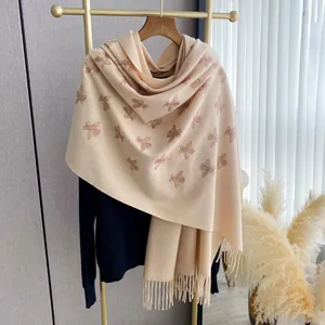 Elegant beige cashmere scarf with embroidered bee pattern and classic fringe details