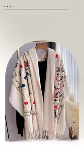 Close-up of elegant floral embroidery and soft tassels on a thick pashmina shawl