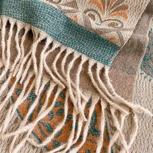 Close-up of ethnic jacquard scarf featuring intricate flower patterns and fringe details