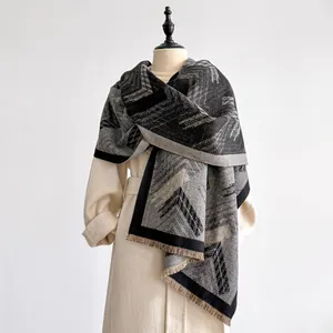 Detail of geometric thick pashmina shawl featuring abstract blocks and fringed edges