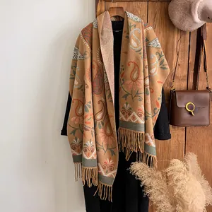 Close-up of bohemian paisley patterned scarf with elegant tassels and thick cashmere texture