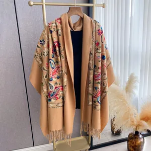 Detail of camel embroidered pashmina shawl with paisley floral patterns and fringe trim