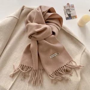Detail shot of soft cashmere-feel scarf with fringe and 10% wool content label