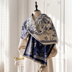Detail of navy blue tropical floral jacquard cashmere scarf with elegant fringe trim