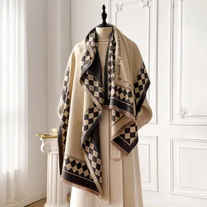 Detail of checkered cashmere shawl with elegant fringe and cursive typography design