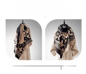 Detail of winter thick shawl showing houndstooth and floral pattern in black and beige