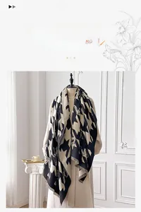 Detail of soft imitation cashmere scarf with classic black and white houndstooth pattern