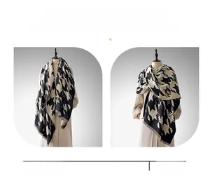 Detail showing thick houndstooth pattern scarf used as both a shawl and a wrap