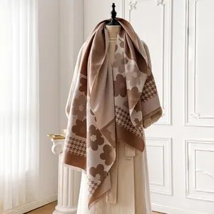 Detail of color-block scarf with large floral print and classic houndstooth patterns