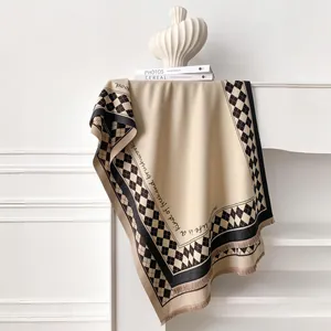 Detail of checkered cashmere-feel scarf with elegant fringes and script typography