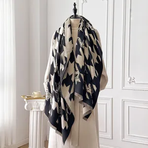 Detail of houndstooth and leopard print scarf with soft fringe on an elegant mannequin