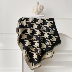 Detail of houndstooth scarf with animal print accents and soft fringe edges