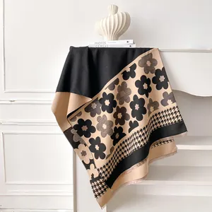 Detailed close-up of double-sided floral scarf with houndstooth pattern and fringe