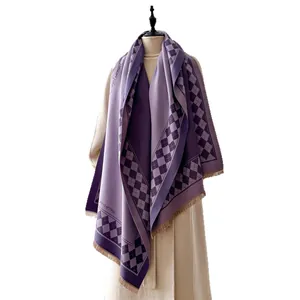 Purple checkerboard cashmere-feel scarf with tassels draped on a mannequin