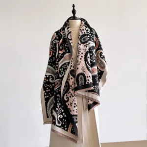 Detailed view of paisley patterns and soft fringe on this thick pashmina shawl scarf