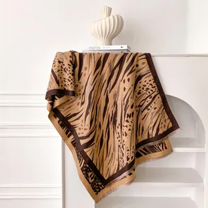 Close-up of leopard and tiger print scarf texture with delicate fringe tassels