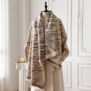 Detail of leopard and zebra print scarf with fringed edges on a classic coat