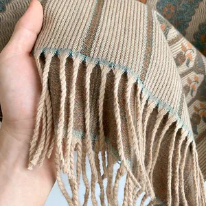 Detailed view of bohemian shawl featuring ethnic floral patterns and thick tassel fringe