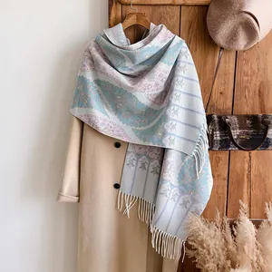 Detailed view of bohemian paisley shawl with delicate fringe on soft cashmere scarf