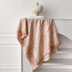 Close-up of leopard and zebra print scarf with fine fringe detail in pink and beige tones