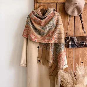 Detail of vintage paisley pattern on thick cashmere shawl with elegant fringe edges