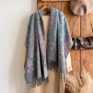 Close-up of bohemian paisley jacquard scarf with elegant fringe details and soft wool texture