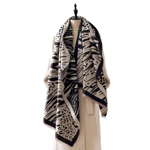 Fashion leopard and zebra print faux cashmere scarf with fringe on a studio mannequin