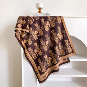 Detail of jacquard cashmere-feel scarf with abstract cat patterns and fringed edges