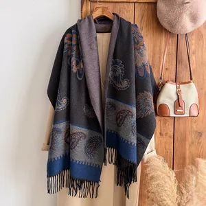 Close-up of vintage paisley embroidery and soft tassel fringe on thick cashmere shawl