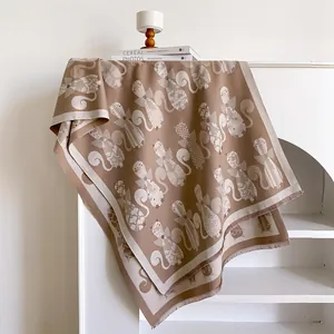 Close-up of jacquard cat pattern on double-sided cashmere-like scarf with fringe