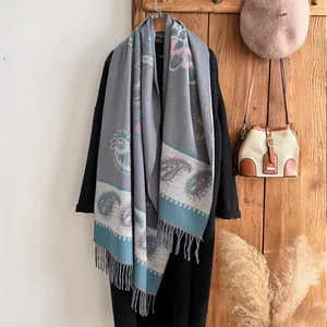 Detail of vintage paisley pattern and tassels on long cashmere-like winter scarf
