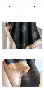 Close-up of double-sided cashmere-like scarf with silver camellia floral patterns and tassels