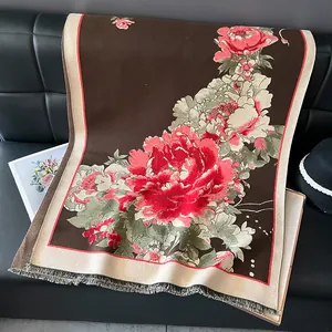 Detail of dark brown pashmina shawl with red peony jacquard pattern and soft grey fringes