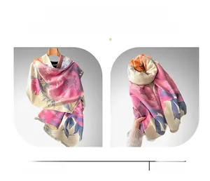 Macro detail of imitation cashmere shawl with pink peony print and fringe edges