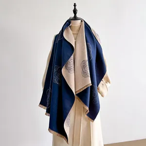 Detail view of double-sided floral cashmere-feel scarf with elegant fringe and flower pattern