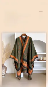 Detail of vintage green oversized shawl with orange trim and elegant butterfly print