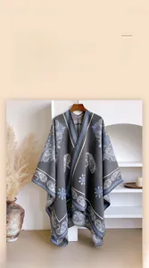 Detail of grey paisley jacquard texture and premium edging on the winter cashmere poncho