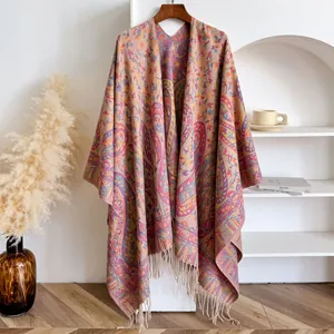 Close-up of bohemian paisley knit shawl with soft colorful fringe and ethnic patterns